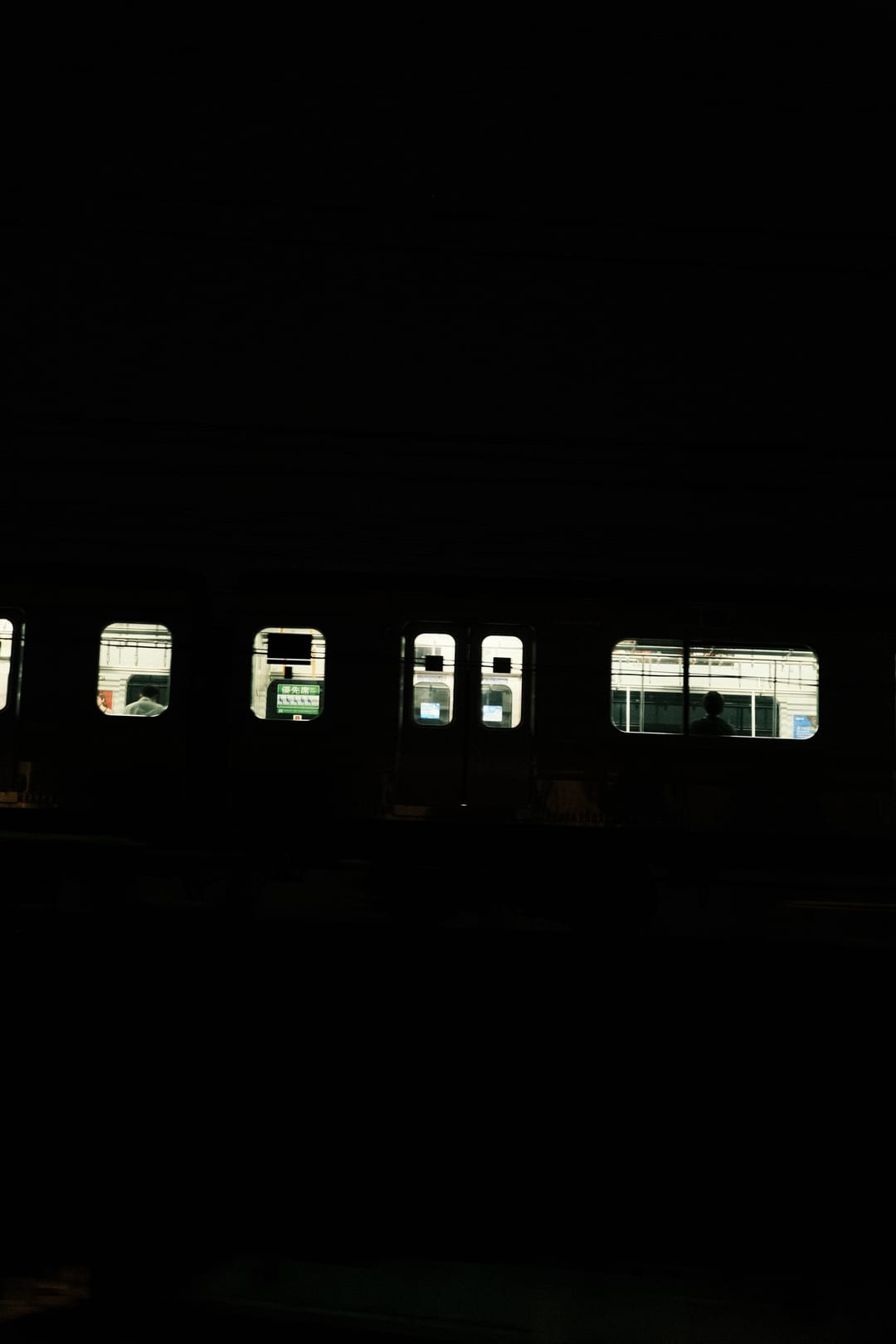 Passengers framed in the windows of a night train